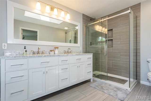 101 Archview Dr, Shiloh, IL 62221 - bathroom with double vanity, a shower stall, and wood finish floors