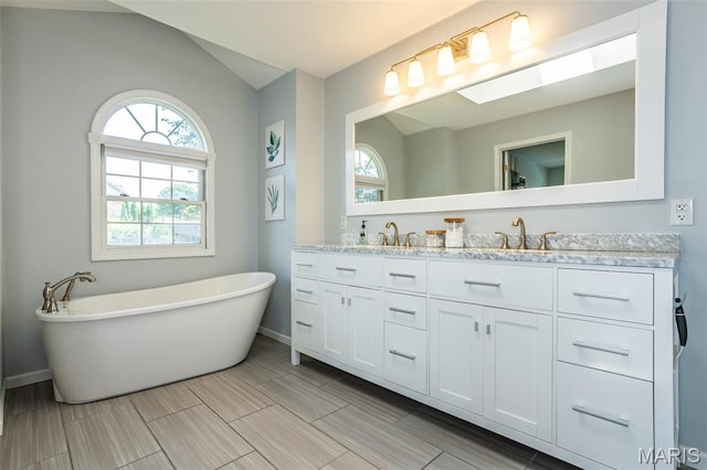 101 Archview Dr, Shiloh, IL 62221 - bathroom with double vanity, a freestanding tub, and lofted ceiling