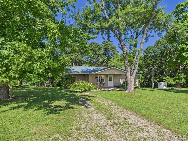 7603 Blue Moon Rd, Bucyrus, MO 65444 - view of front of house with a storage unit, a front lawn, and a porch