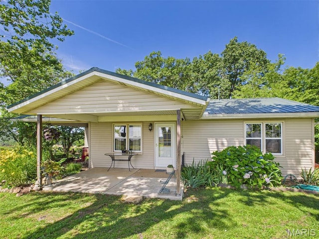 7603 Blue Moon Rd, Bucyrus, MO 65444 - back of property with a lawn and a metal roof