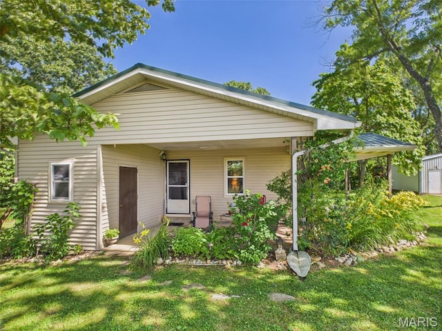 7603 Blue Moon Rd, Bucyrus, MO 65444 - rear view of property featuring a porch and a yard