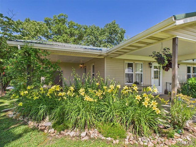 7603 Blue Moon Rd, Bucyrus, MO 65444 - view of property exterior featuring a metal roof and a porch