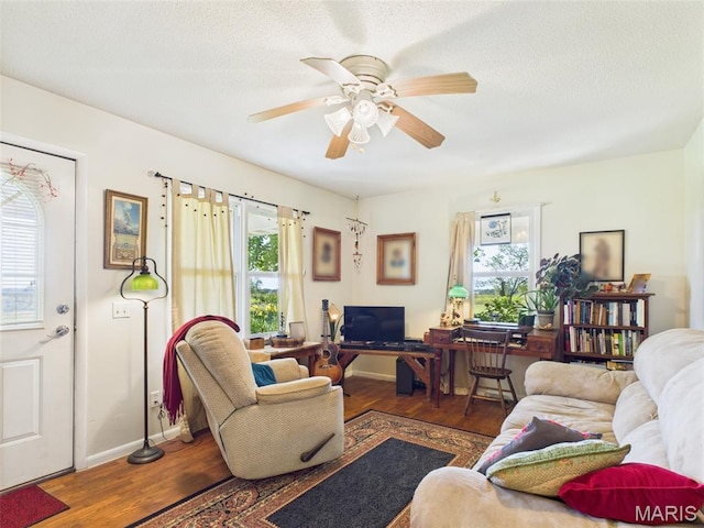 7603 Blue Moon Rd, Bucyrus, MO 65444 - living room featuring wood finished floors, healthy amount of natural light, and ceiling fan