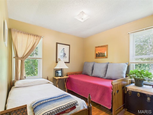 7603 Blue Moon Rd, Bucyrus, MO 65444 - bedroom featuring wood finished floors and a textured ceiling