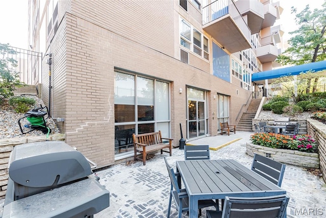 210 N 17th St Unit 905, Saint Louis, MO 63103 - view of patio / terrace with stairs, area for grilling, and outdoor dining area