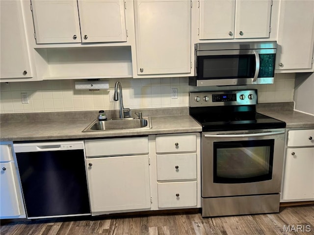 4229 Carrollton Dr Unit C, Bridgeton, MO 63044 - kitchen featuring appliances with stainless steel finishes, white cabinets, decorative backsplash, and dark wood-type flooring