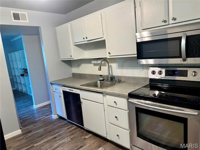 4229 Carrollton Dr Unit C, Bridgeton, MO 63044 - kitchen with stainless steel appliances, dark wood-style floors, white cabinetry, and backsplash
