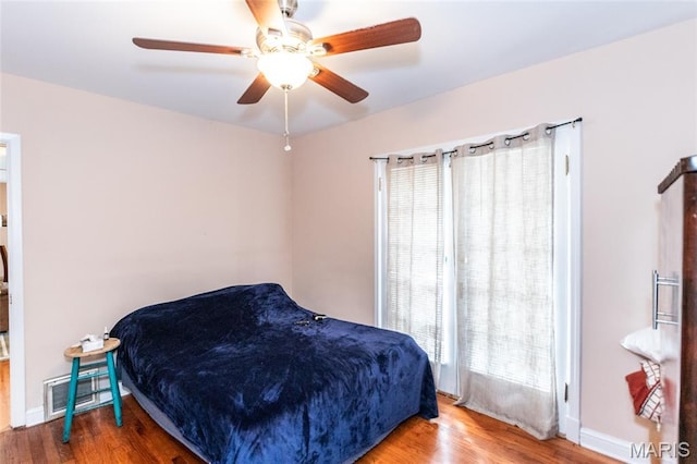 9705 Riverview Dr, Saint Louis, MO 63137 - bedroom featuring multiple windows, wood finished floors, and ceiling fan