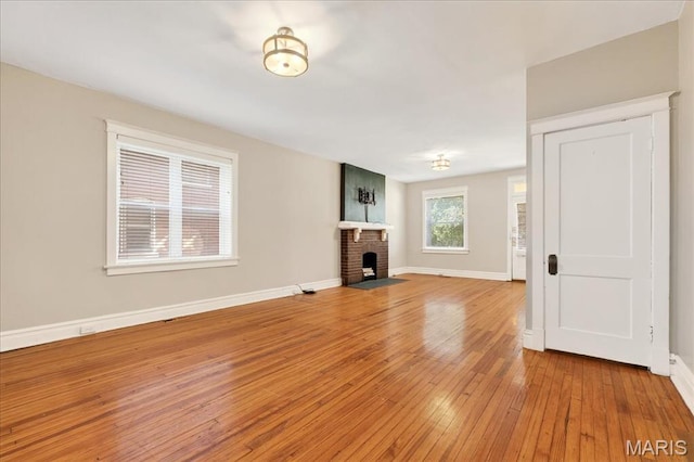 2057-2059 Ann Ave, Saint Louis, MO 63104 - unfurnished living room with light wood finished floors and a fireplace