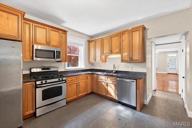 2057-2059 Ann Ave, Saint Louis, MO 63104 - kitchen with stainless steel appliances, plenty of natural light, and brown cabinetry