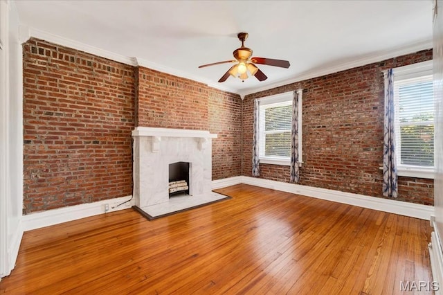 2057-2059 Ann Ave, Saint Louis, MO 63104 - unfurnished living room with a ceiling fan, brick wall, hardwood / wood-style floors, crown molding, and a high end fireplace
