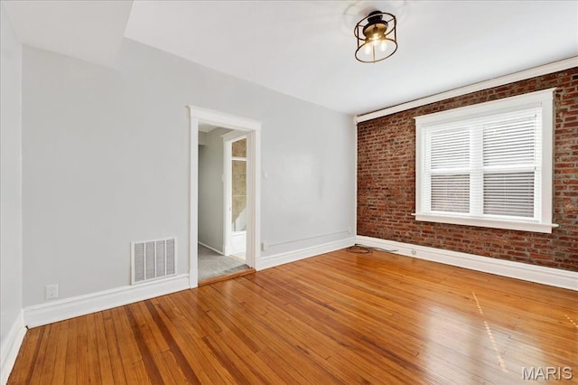 2057-2059 Ann Ave, Saint Louis, MO 63104 - empty room featuring brick wall and hardwood / wood-style floors