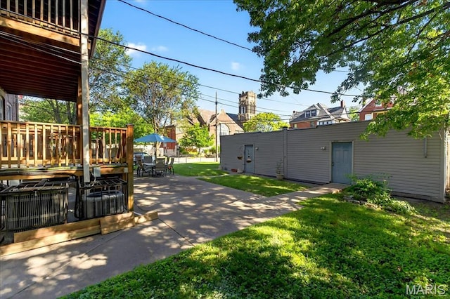 2057-2059 Ann Ave, Saint Louis, MO 63104 - view of green lawn with a patio area, a deck, and outdoor dining space