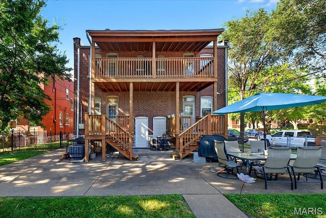 2057-2059 Ann Ave, Saint Louis, MO 63104 - rear view of house featuring a balcony, stairway, brick siding, and a patio area