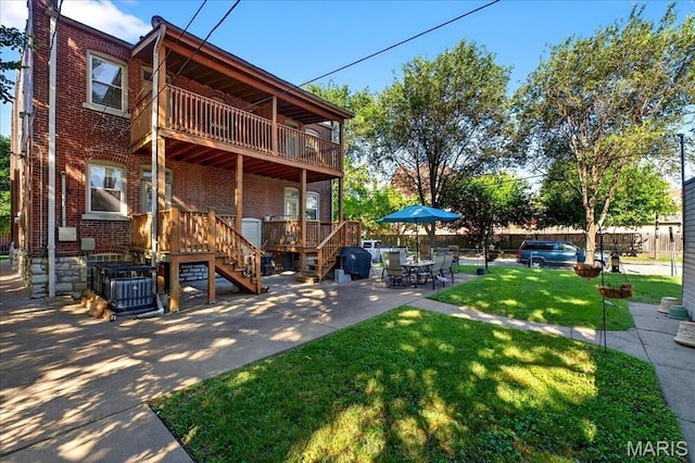 2057-2059 Ann Ave, Saint Louis, MO 63104 - rear view of property featuring brick siding, a lawn, a balcony, a patio area, and stairway