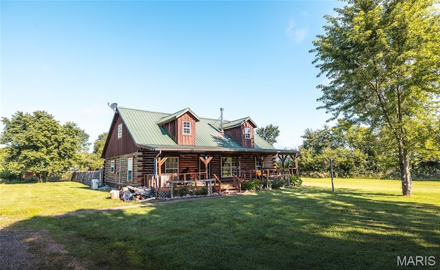 19612 State Route M, Edgar Springs, MO 65462 - view of front of house featuring log siding, a front yard, a porch, and a metal roof