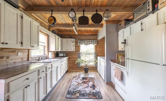 19612 State Route M, Edgar Springs, MO 65462 - kitchen featuring white appliances, a wood ceiling with exposed beams, healthy amount of natural light, wood walls, and light wood finished floors