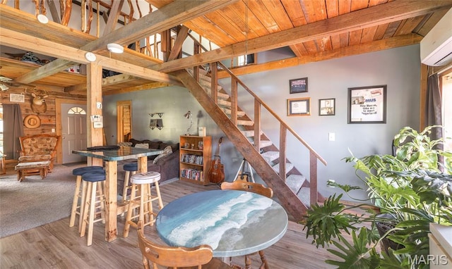 19612 State Route M, Edgar Springs, MO 65462 - dining space featuring a wall unit AC, a wood ceiling with exposed beams, wood finished floors, and stairs