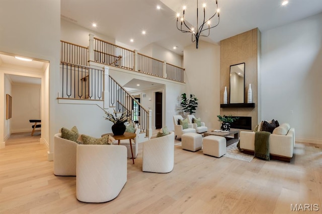 224 Oak Tree Dr, Webster Groves, MO 63119 - living area featuring a towering ceiling, wood finished floors, stairway, a chandelier, and recessed lighting
