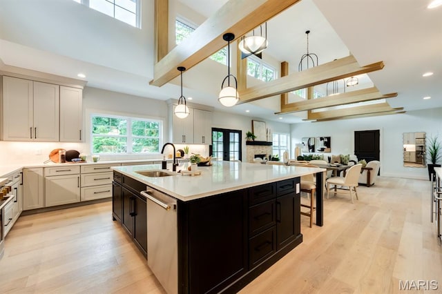 224 Oak Tree Dr, Webster Groves, MO 63119 - kitchen featuring high vaulted ceiling, stainless steel dishwasher, light countertops, light wood-style floors, and recessed lighting
