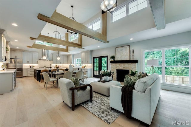 224 Oak Tree Dr, Webster Groves, MO 63119 - living room with a towering ceiling, light wood-style floors, recessed lighting, and a fireplace