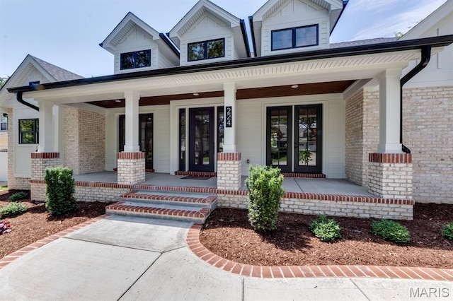 224 Oak Tree Dr, Webster Groves, MO 63119 - view of exterior entry featuring covered porch and brick siding