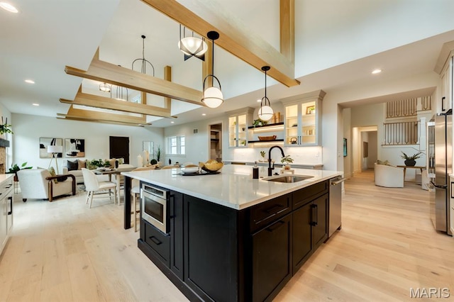 224 Oak Tree Dr, Webster Groves, MO 63119 - kitchen featuring stainless steel appliances, high vaulted ceiling, light wood finished floors, light countertops, and glass insert cabinets