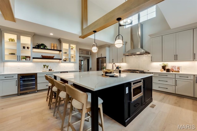 224 Oak Tree Dr, Webster Groves, MO 63119 - kitchen featuring wine cooler, wall chimney exhaust hood, high vaulted ceiling, stainless steel appliances, and light countertops
