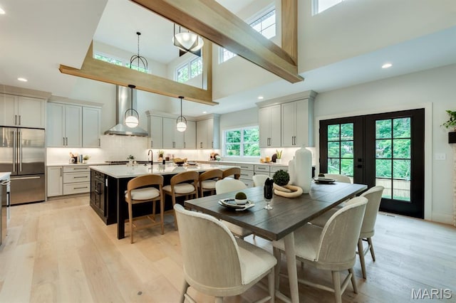 224 Oak Tree Dr, Webster Groves, MO 63119 - dining area with high vaulted ceiling, light wood-style flooring, recessed lighting, and french doors