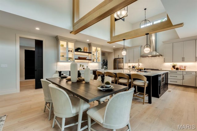224 Oak Tree Dr, Webster Groves, MO 63119 - dining space with high vaulted ceiling, light wood finished floors, and recessed lighting