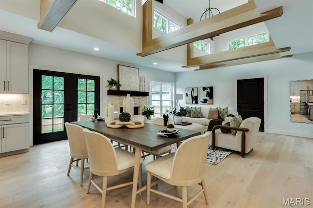 224 Oak Tree Dr, Webster Groves, MO 63119 - dining room featuring a towering ceiling, light wood-style floors, recessed lighting, and french doors