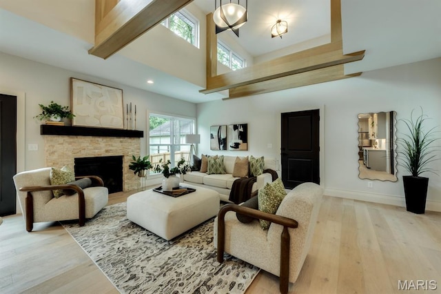 224 Oak Tree Dr, Webster Groves, MO 63119 - living area with light wood-type flooring, a stone fireplace, a towering ceiling, and recessed lighting