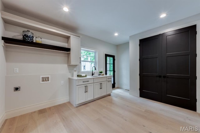 224 Oak Tree Dr, Webster Groves, MO 63119 - laundry room with electric dryer hookup, hookup for a washing machine, light wood finished floors, and recessed lighting