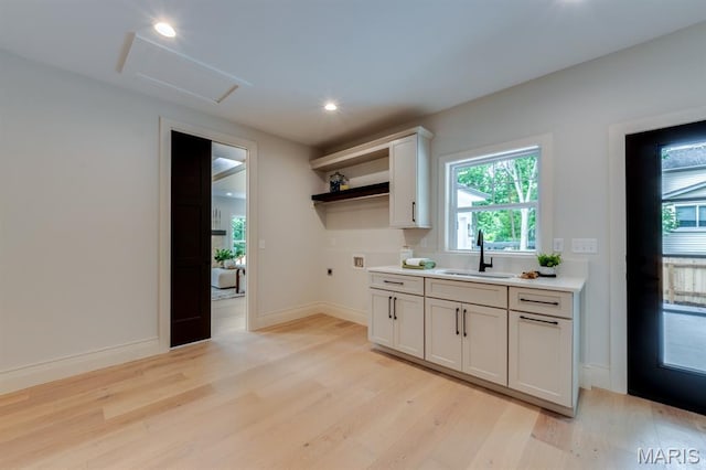 224 Oak Tree Dr, Webster Groves, MO 63119 - kitchen featuring open shelves, light wood-style floors, light countertops, healthy amount of natural light, and recessed lighting