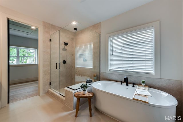 224 Oak Tree Dr, Webster Groves, MO 63119 - full bath with a soaking tub, a shower stall, and tile patterned floors