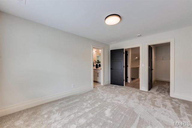 224 Oak Tree Dr, Webster Groves, MO 63119 - unfurnished bedroom with light colored carpet, a spacious closet, a closet, and ensuite bathroom
