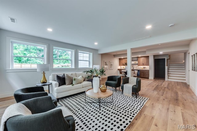 224 Oak Tree Dr, Webster Groves, MO 63119 - living room with plenty of natural light, light wood-type flooring, recessed lighting, and stairway