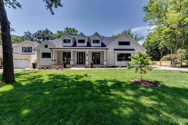 224 Oak Tree Dr, Webster Groves, MO 63119 - modern farmhouse style home featuring brick siding, covered porch, a front lawn, and board and batten siding