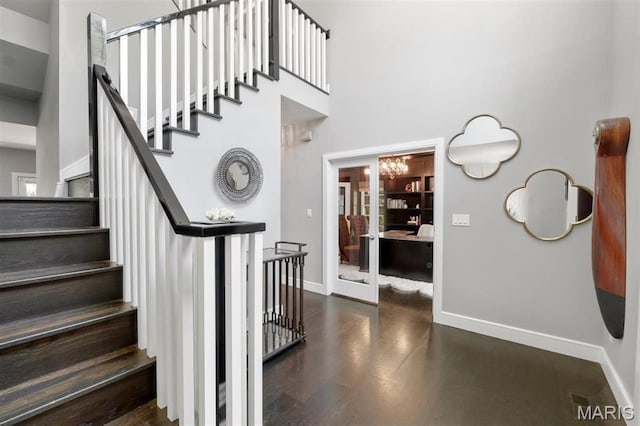 12429 Nicholas Ln, Saint Louis, MO 63131 - stairs featuring a high ceiling and a chandelier