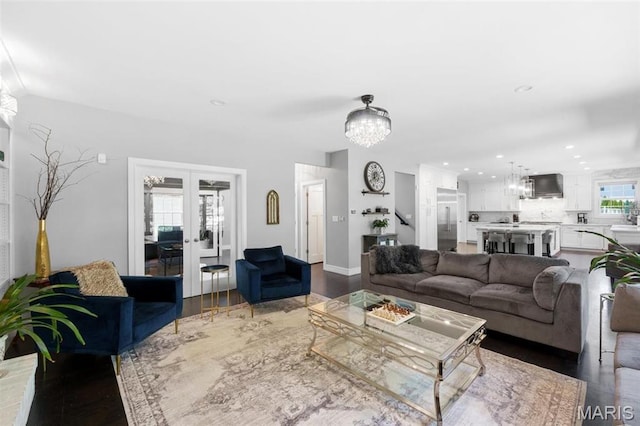12429 Nicholas Ln, Saint Louis, MO 63131 - living room featuring a chandelier, recessed lighting, french doors, and wood finished floors