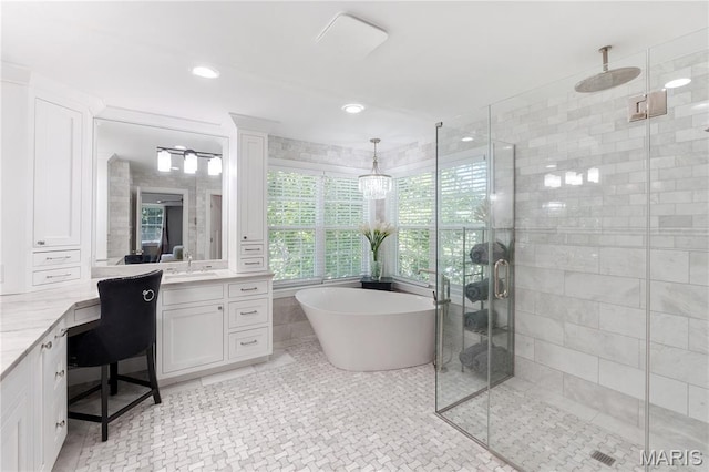 12429 Nicholas Ln, Saint Louis, MO 63131 - full bathroom with vanity, a stall shower, a soaking tub, tile walls, and recessed lighting