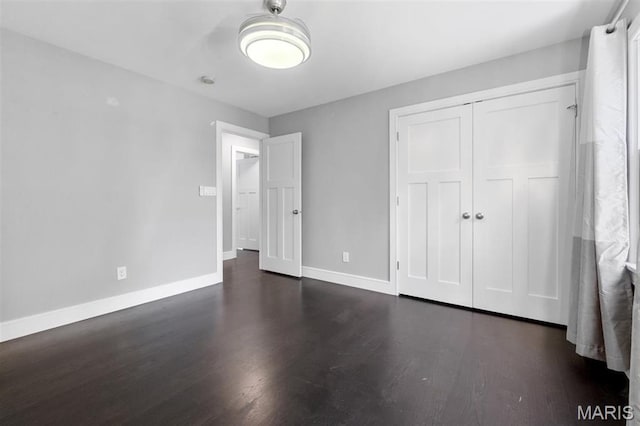 12429 Nicholas Ln, Saint Louis, MO 63131 - unfurnished bedroom featuring dark wood-type flooring and a closet