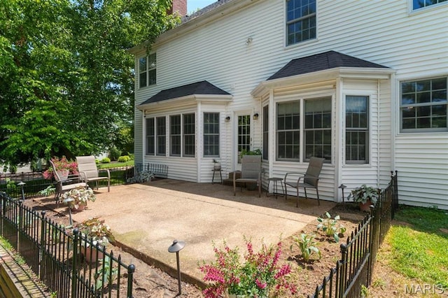 12429 Nicholas Ln, Saint Louis, MO 63131 - back of house featuring a patio and a chimney