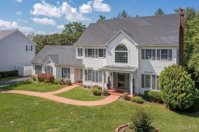12429 Nicholas Ln, Saint Louis, MO 63131 - colonial inspired home with a front lawn, a chimney, and a shingled roof