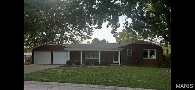 2518 Ford Dr, Cape Girardeau, MO 63701 - ranch-style house with an attached garage, concrete driveway, and a front lawn