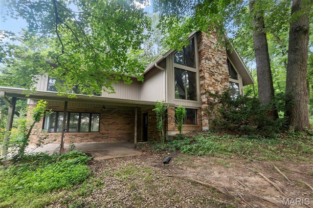 1938 State Highway Oo, Whitewater, MO 63785 - mid-century home featuring a patio, brick siding, and a chimney