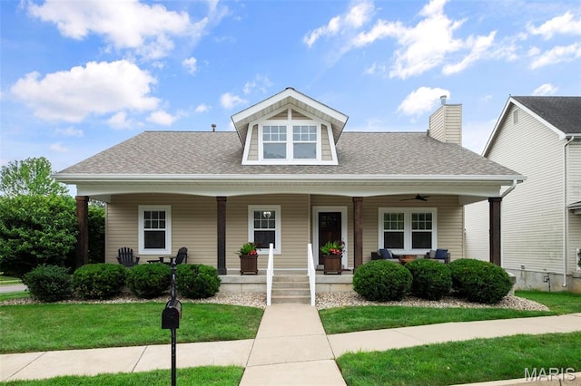 17108 Windsor Crest Blvd, Wildwood, MO 63038 - bungalow-style home featuring roof with shingles, a front lawn, covered porch, ceiling fan, and a chimney
