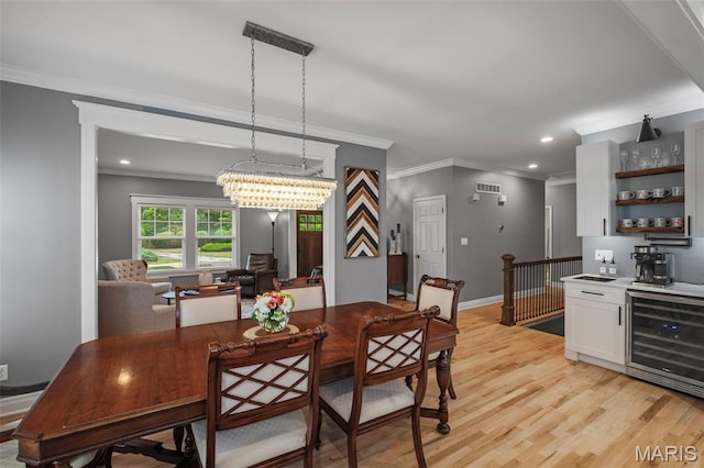 17108 Windsor Crest Blvd, Wildwood, MO 63038 - dining area with beverage cooler, ornamental molding, light wood-style flooring, recessed lighting, and bar