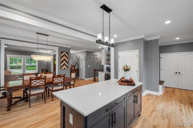 17108 Windsor Crest Blvd, Wildwood, MO 63038 - kitchen featuring crown molding, recessed lighting, light wood-type flooring, light countertops, and a center island