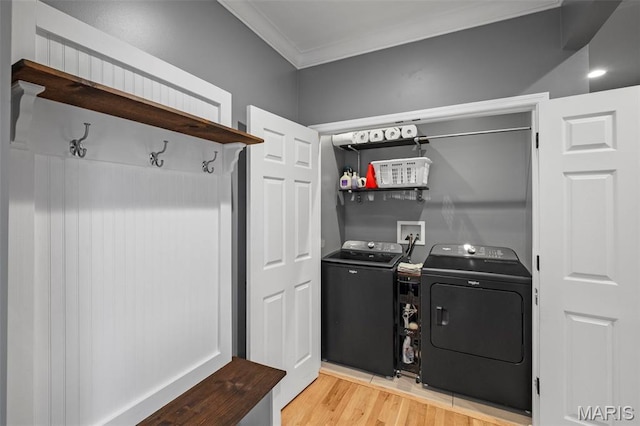 17108 Windsor Crest Blvd, Wildwood, MO 63038 - laundry area featuring independent washer and dryer, crown molding, and light wood-style floors